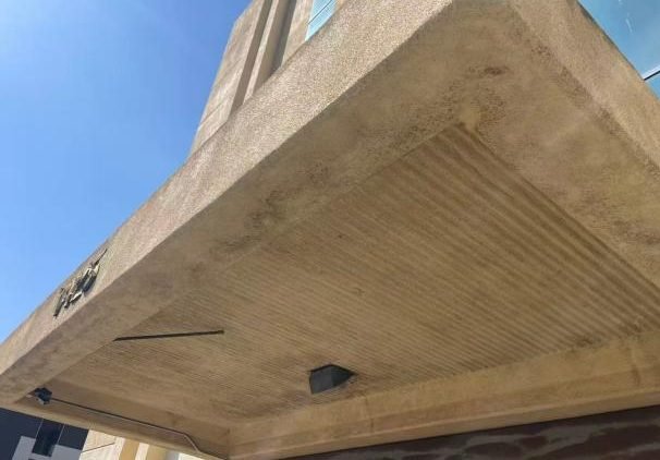 Weathered entrance canopy soffit on ageing commercial building — WUMEI survey