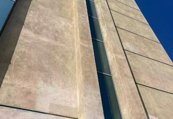 Stained and weathered facade cladding on commercial building — WUMEI survey
