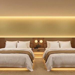 Design rendering of Double Queen hotel room with upholstered headboard wall — WUMEI